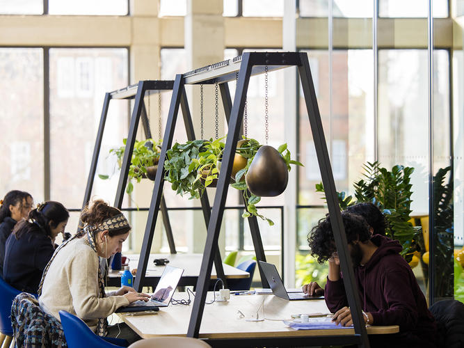 students working at a desk in the Manor Road Building