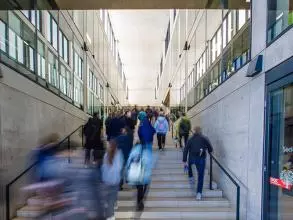 blurred image of a group of people walking up and down a flight of stairs